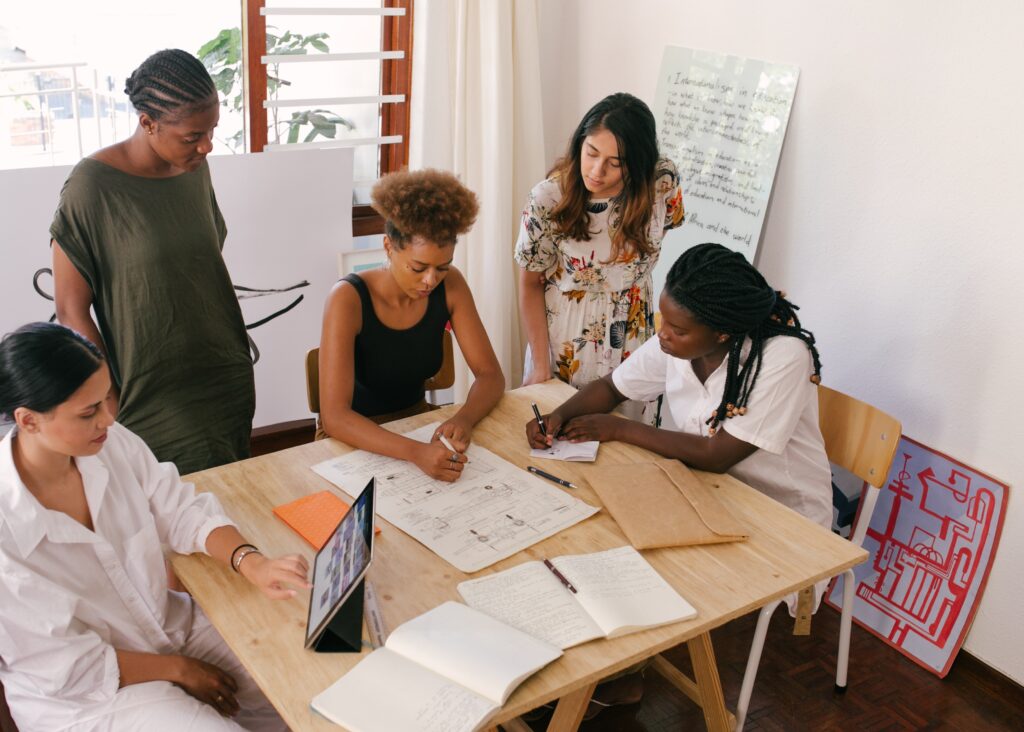 Top Pre-Seed Funds: Founders Huddled Around App Designs